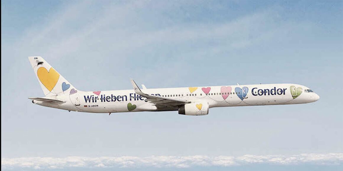 Condor Flugzeug Willi. Weißer Flieger mit bunten Herzen und dem Schriftzug 