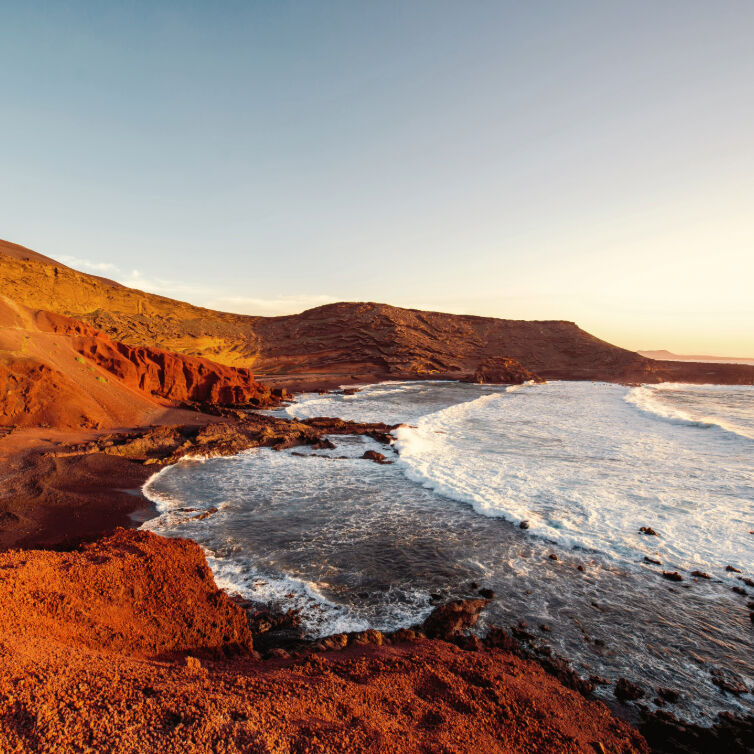 Bucht El Golfo mit Fischerbooten bei Sonnenuntergang