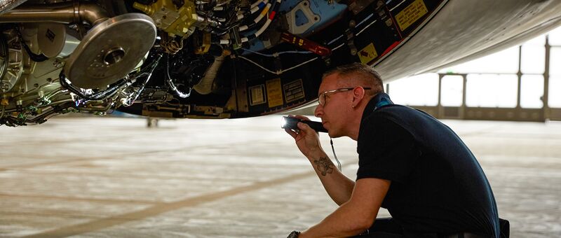 Condor Technik employee inspecting aircraft