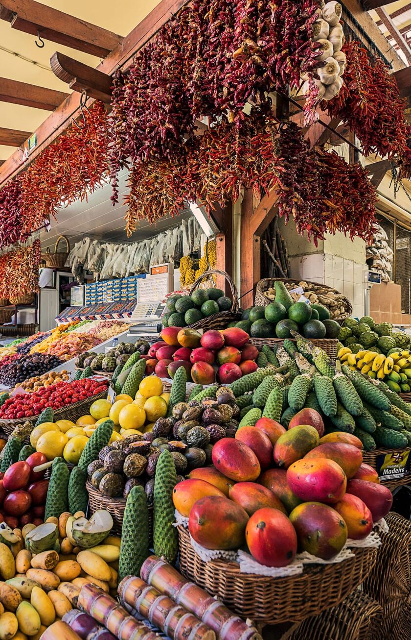 A Mediterranean outdoor market with fruit, vegetables and spice stalls