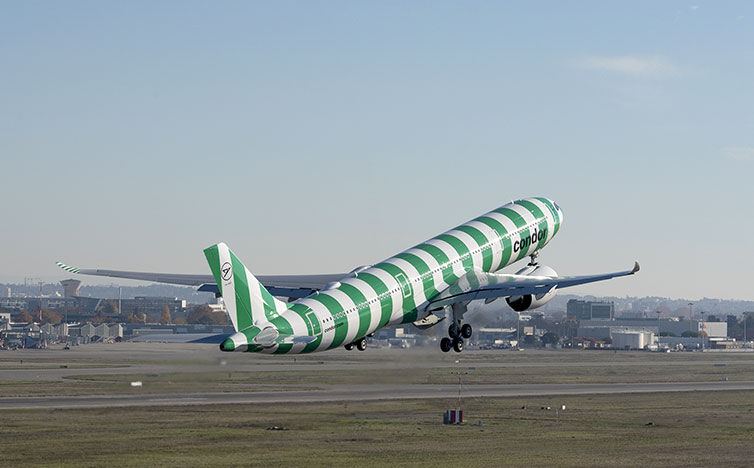 A green-white Airbus A330neo takes off at the airport