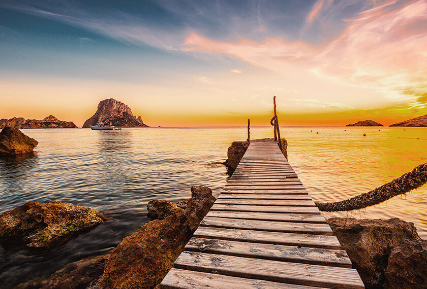 Awesone view of the sunset over the Mediterranean Sea from a pier in Ibiza, Spain